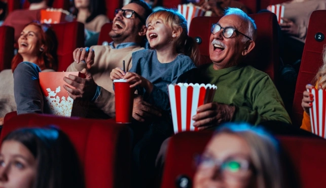 Group of people eating popcorn enjoying the Cinema